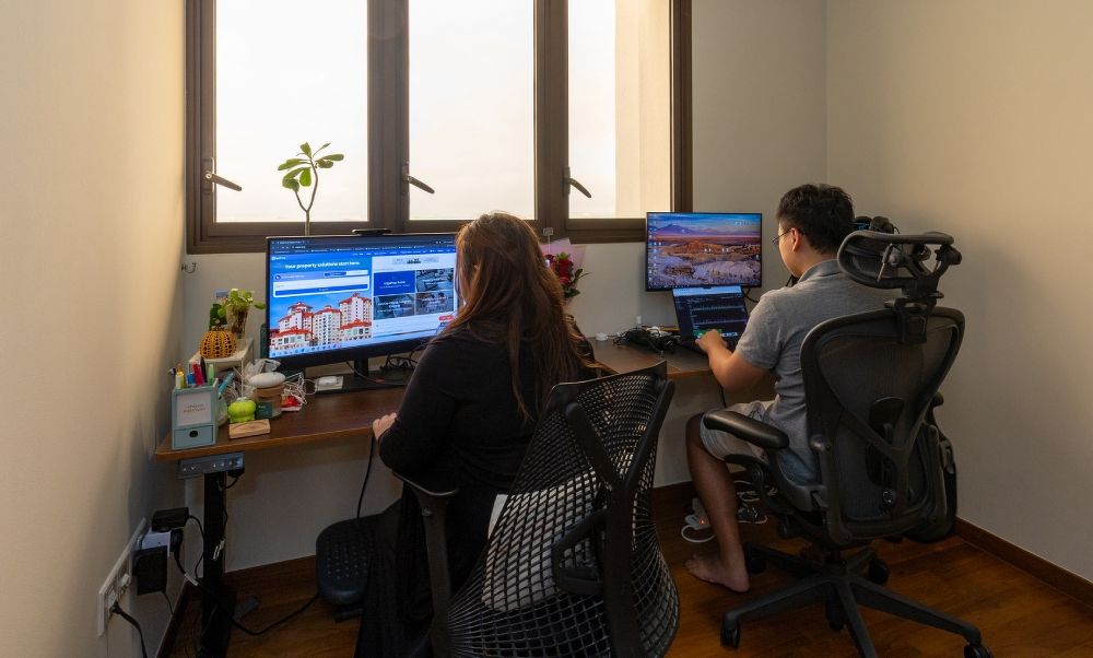 The couple at their workspaces at home