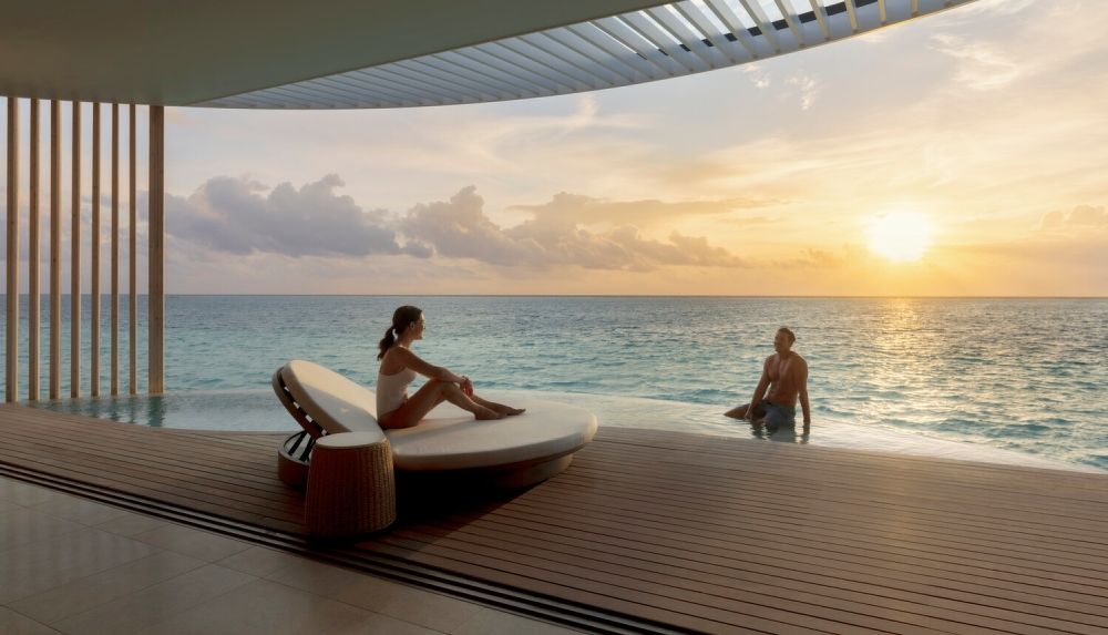 A couple at a luxury travel accommodation with ocean view