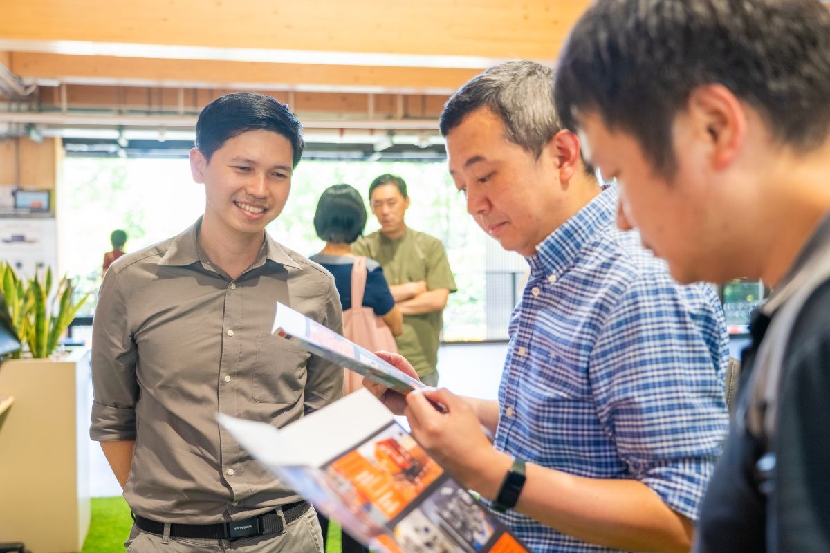 Visitors looking at brochures at the Geonamics booth