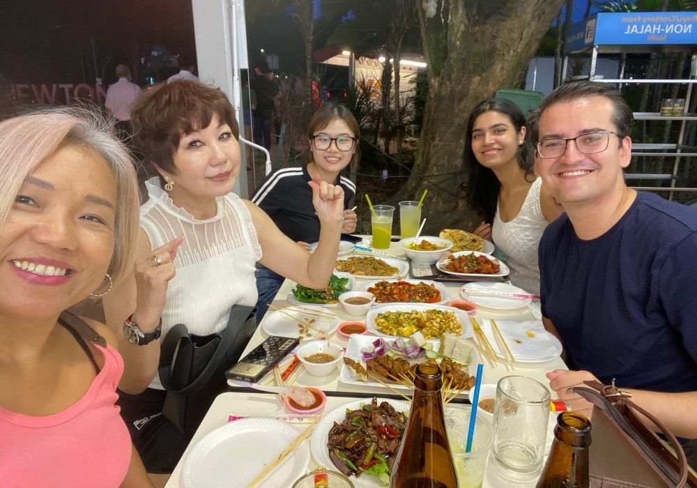 A group photo of Bespoke Habitat's landlord partner, agent, and international student residents at a farewell dinner