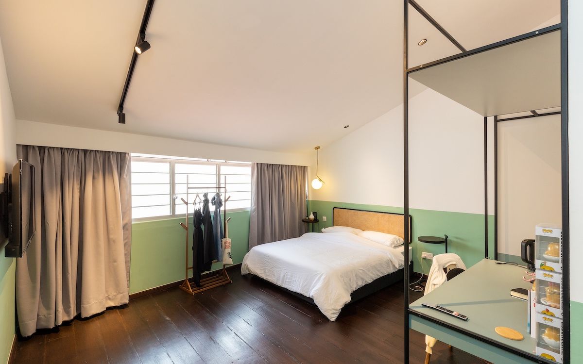 An ensuite bedroom with a bed and a desk, under the "TAP Luxe" room type, at The Assembly Place's co-living property.