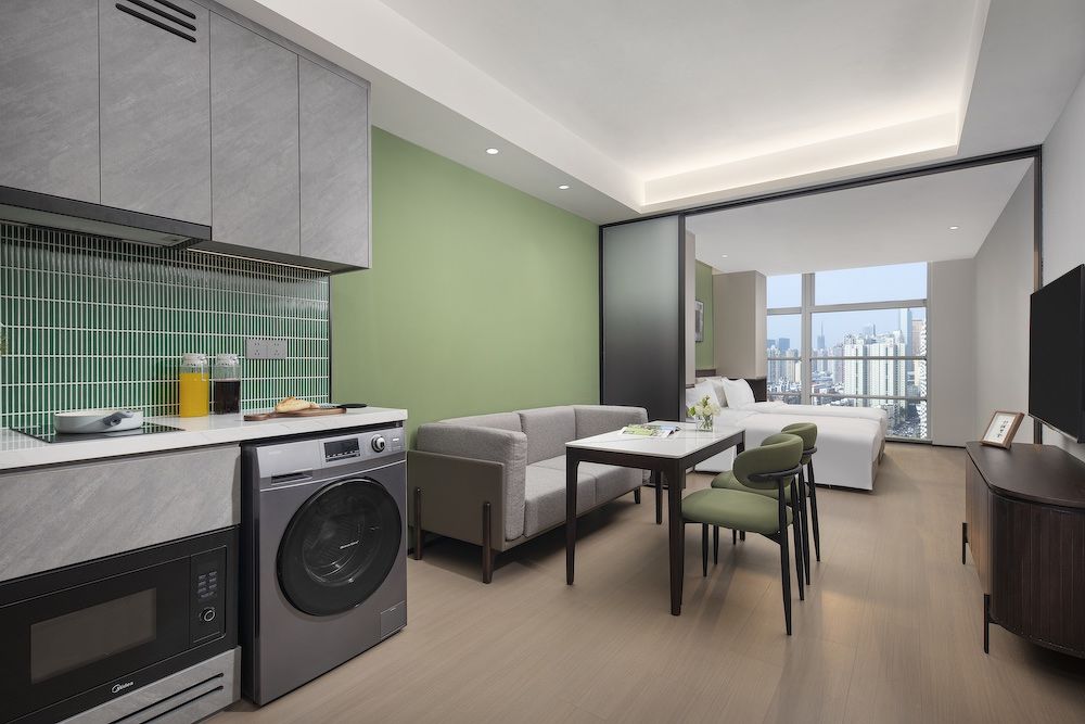 The studio deluxe twin unit at Modena by Fraser Shenzhen includes a kitchenette with a microwave oven, washer-dryer, a living area or 'hobby zone', TV, ensuite bathroom, and more.