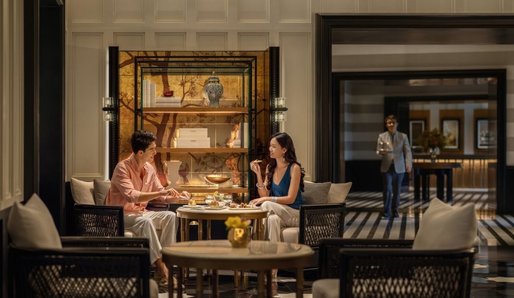 Young affluent travellers from Asia Pacific in luxury hotel lounge