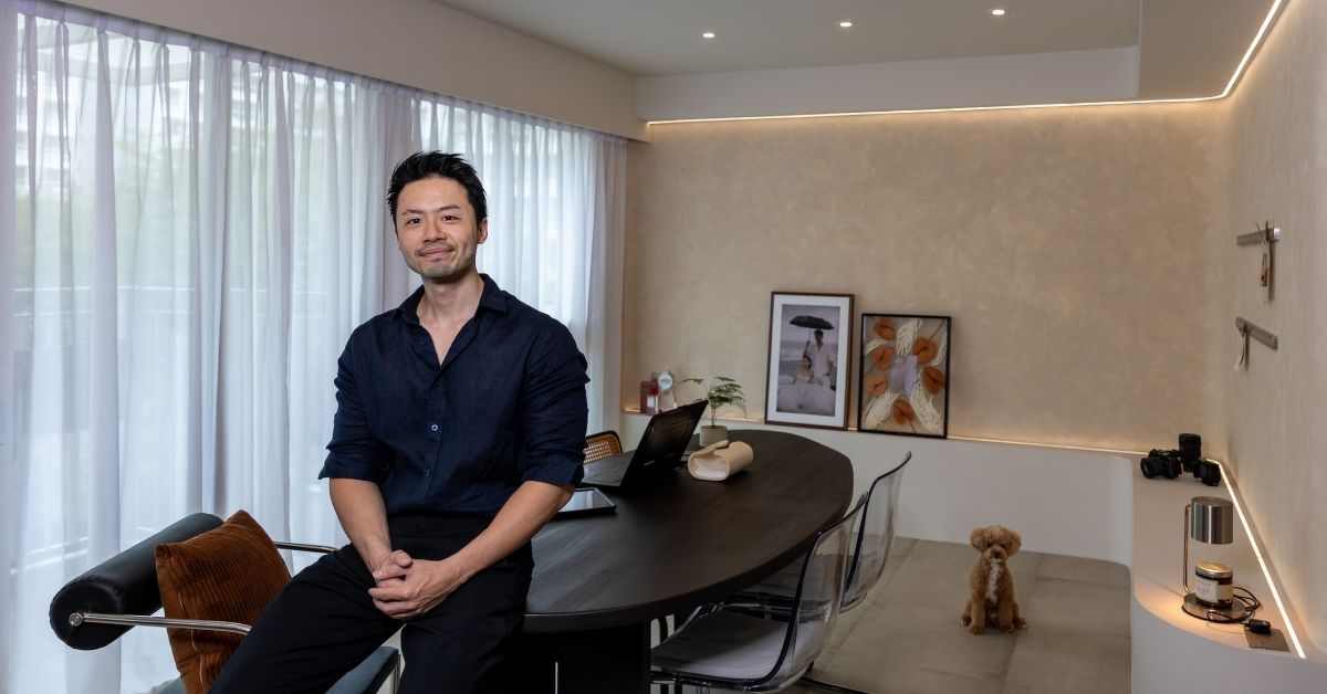 PropNex real estate agent Jerome Yap at home with his camera gear and pet dog