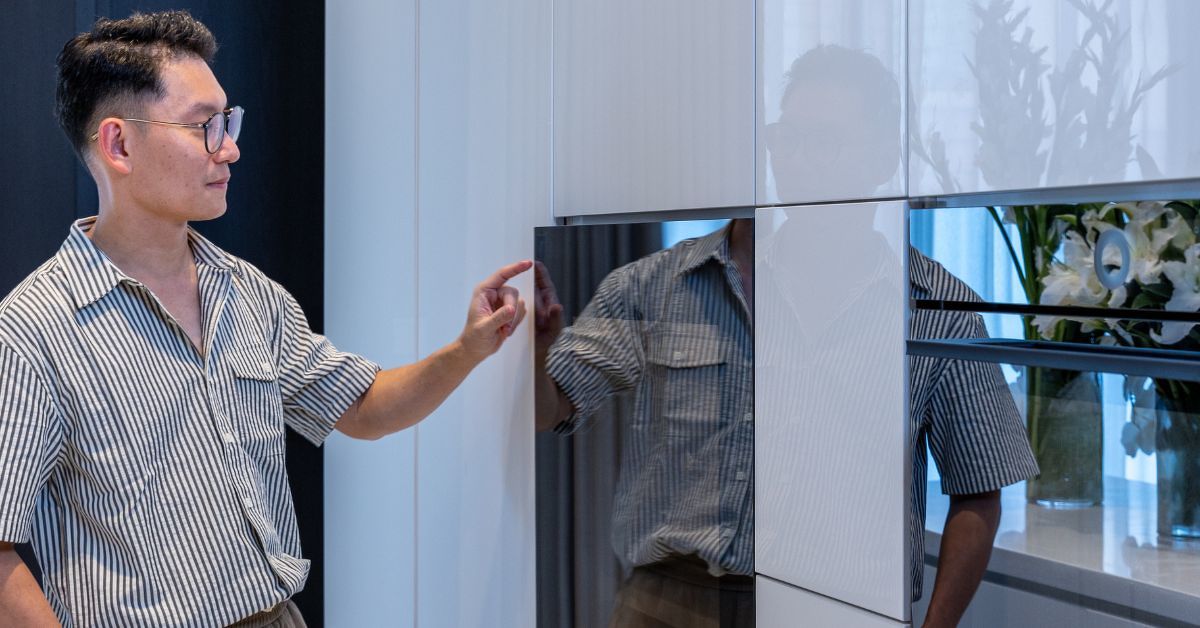 Queck opens the WineCooler V4000, which forms part of the integrated appliance suite in the open-plan kitchen