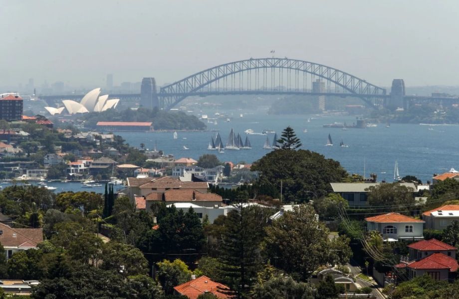 Residential buildings with the famous Sydney Harbour Bridge and opera house in the background. Photo: Bloomberg